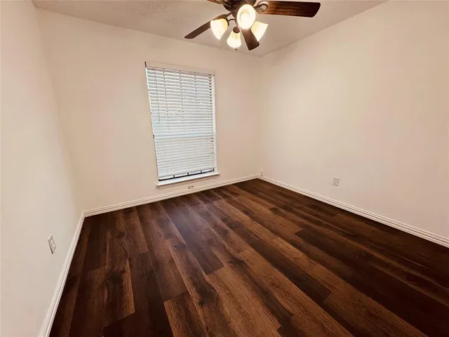 wooden floor in a hall with a window