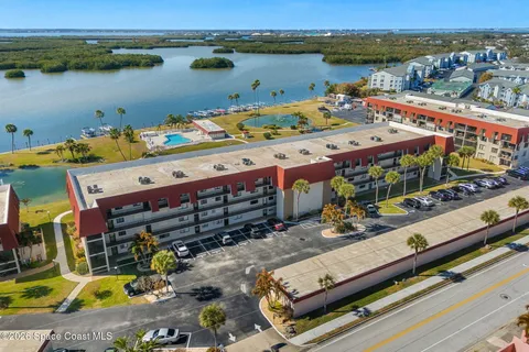 a view of a lake with couches chairs