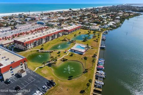 an aerial view of a residential houses with outdoor space and swimming pool