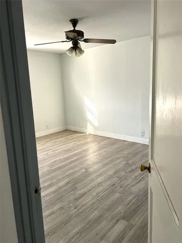 a view of a room with wooden floor