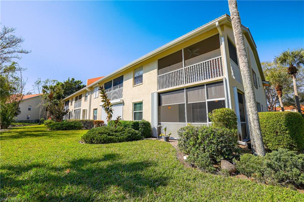 305 Robin Hood Circle, Unit 101 Naples, FL 34104 - Photo 20 of 31 a front view of a house with garden