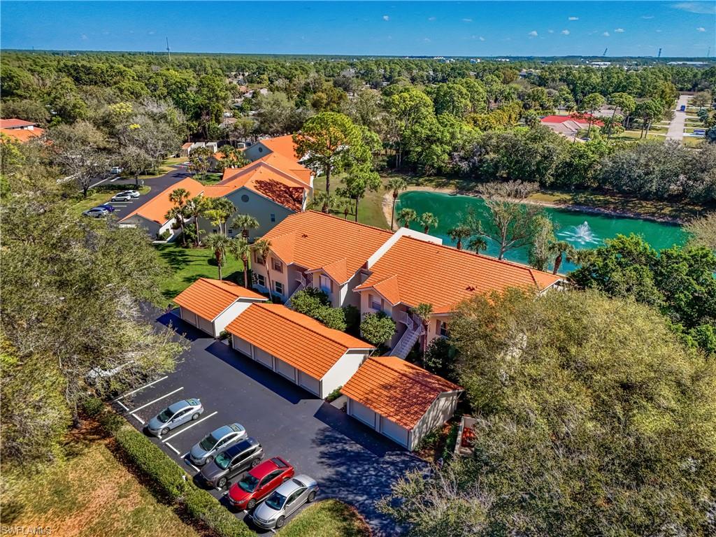 305 Robin Hood Circle, Unit 101 Naples, FL 34104 - Photo 2 of 31 an aerial view of a house with a yard
