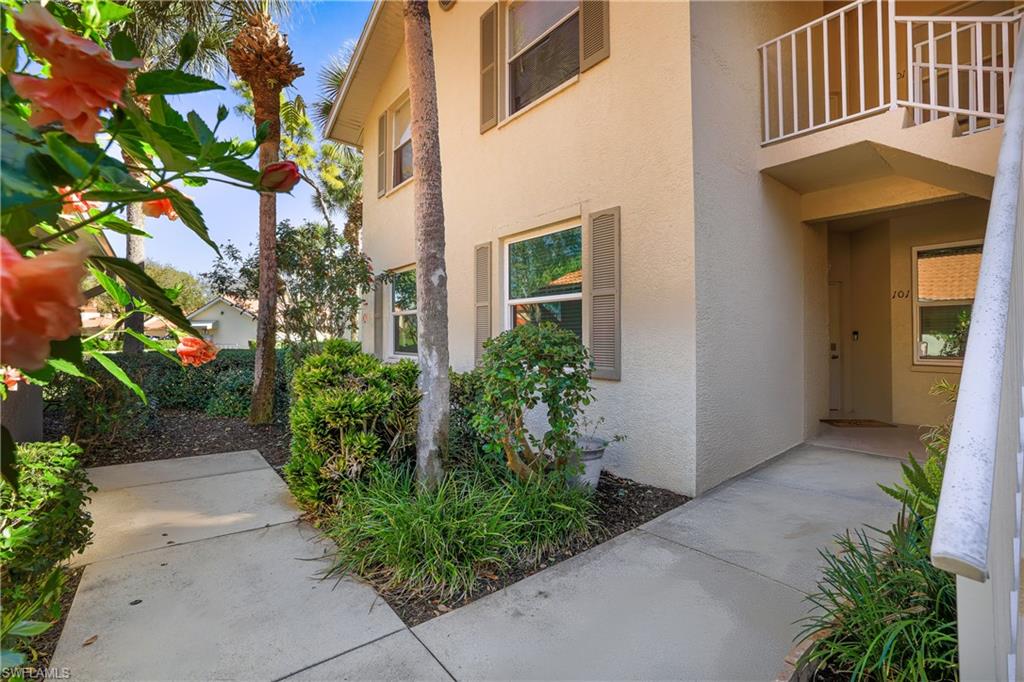 305 Robin Hood Circle, Unit 101 Naples, FL 34104 - Photo 21 of 31 a view of a pathway along the building