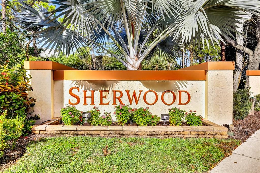 305 Robin Hood Circle, Unit 101 Naples, FL 34104 - Photo 22 of 31 a street sign on the side of the road