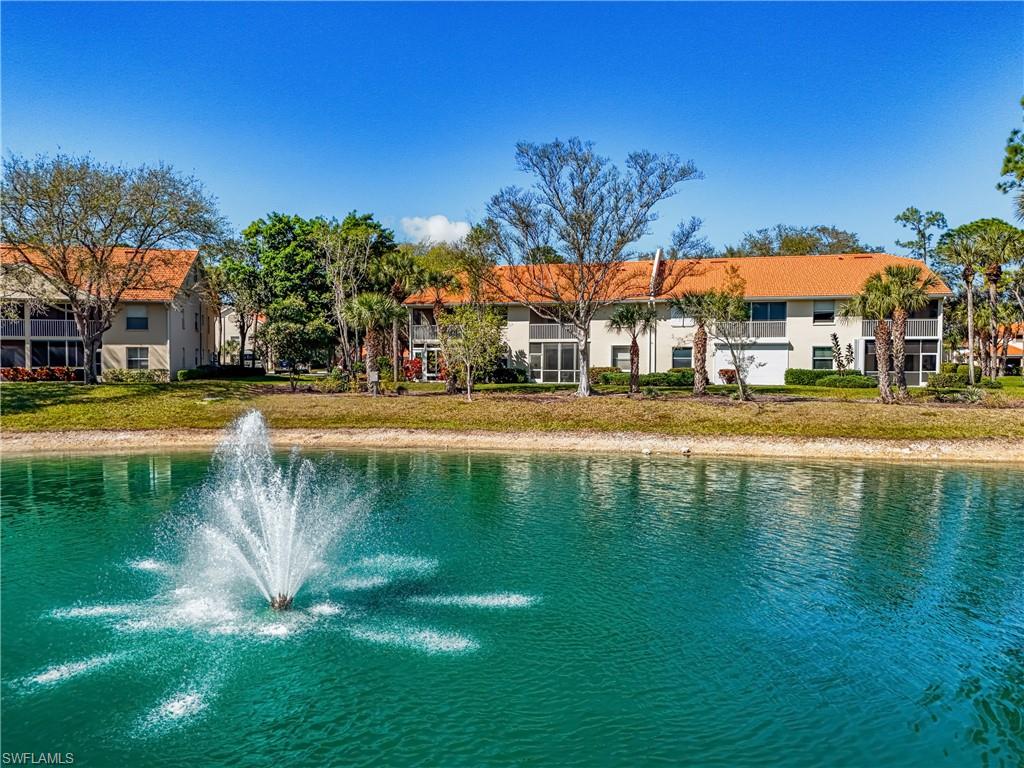305 Robin Hood Circle, Unit 101 Naples, FL 34104 - Photo 23 of 31 a swimming pool with outdoor seating and yard