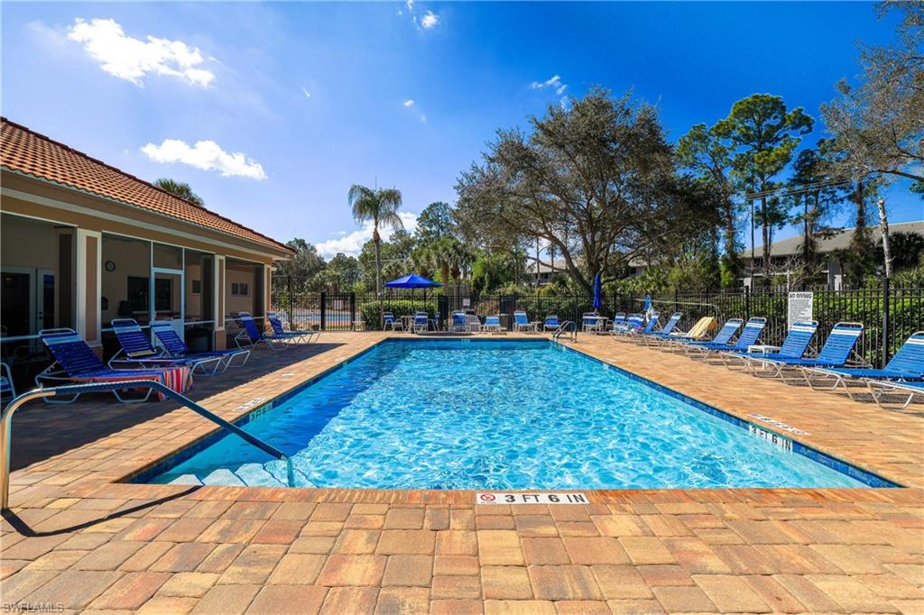 305 Robin Hood Circle, Unit 101 Naples, FL 34104 - Photo 27 of 31 a view of outdoor space with swimming pool and furniture