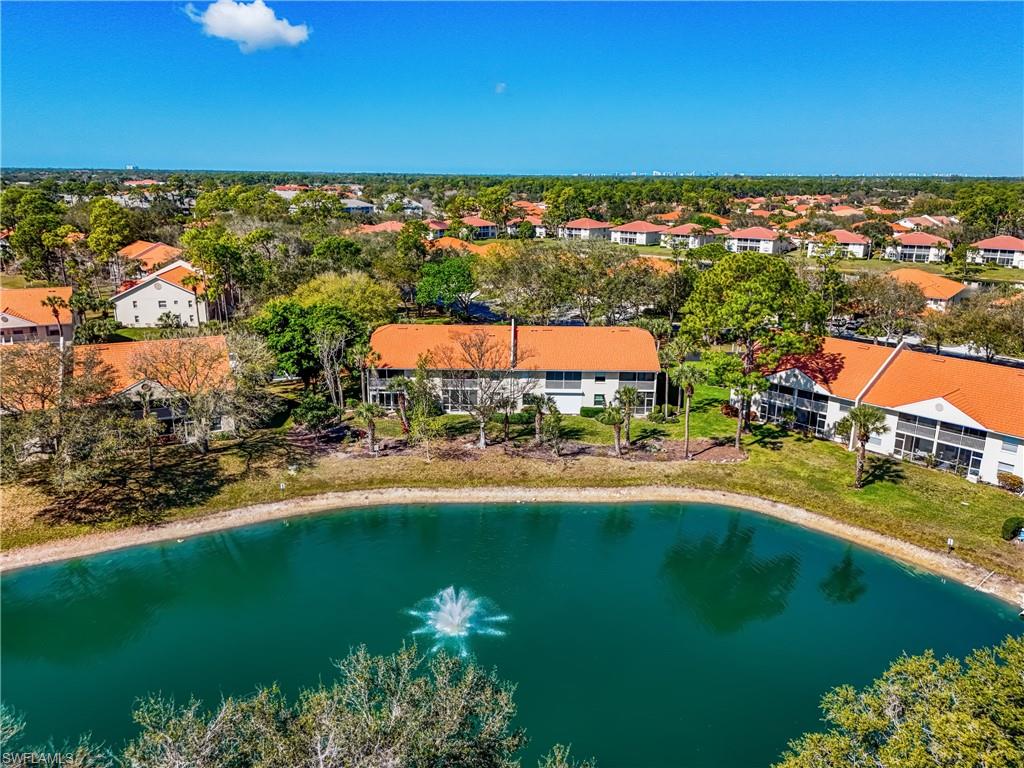 305 Robin Hood Circle, Unit 101 Naples, FL 34104 - Photo 3 of 31 an aerial view of a houses with a yard