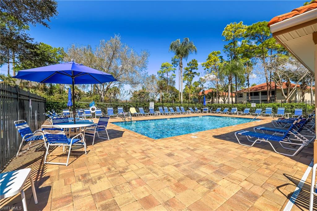 305 Robin Hood Circle, Unit 101 Naples, FL 34104 - Photo 31 of 31 a view of a swimming pool with sitting area