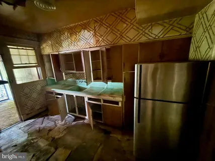a kitchen with stainless steel appliances granite countertop a refrigerator a stove and a sink