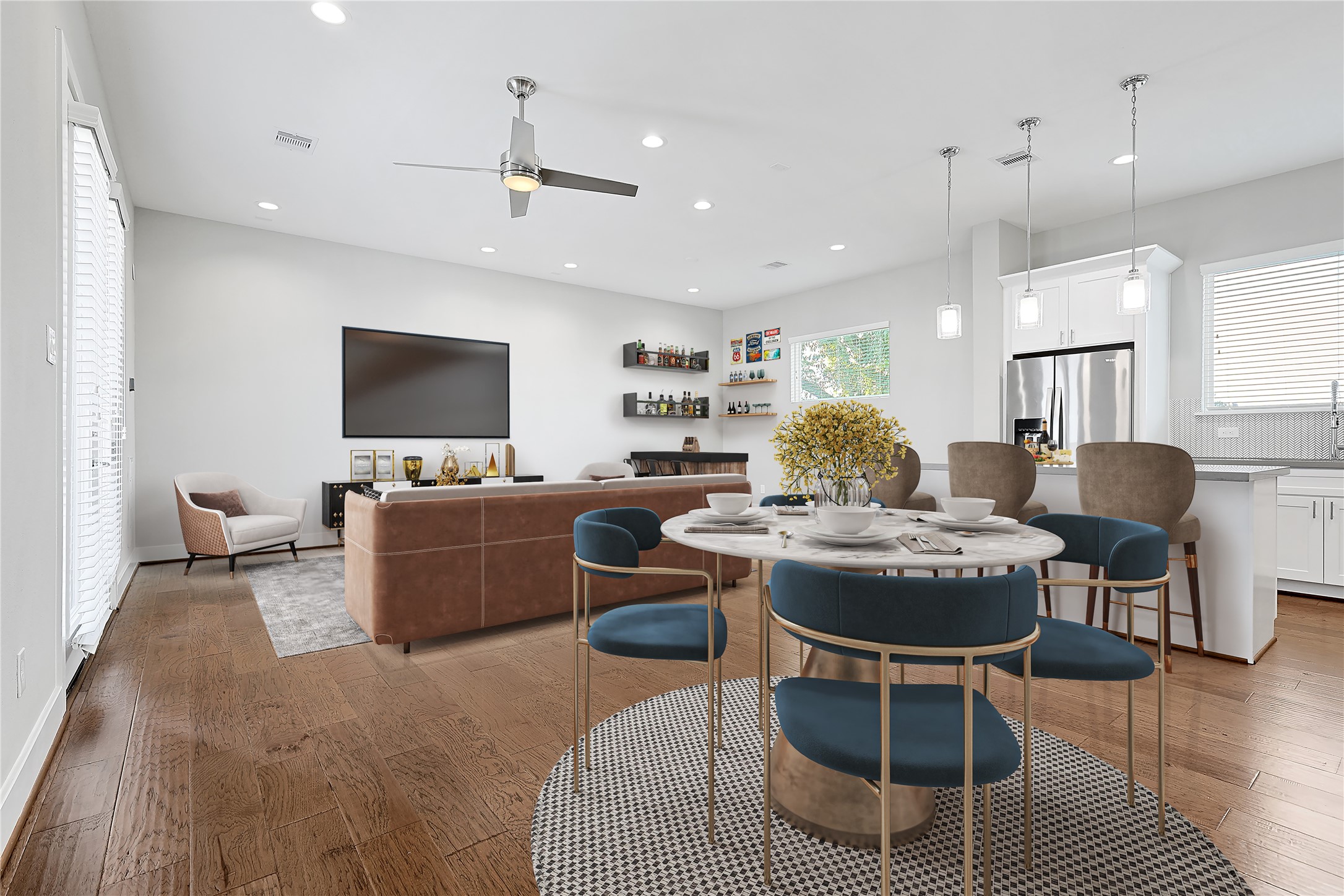 a living room with furniture a flat screen tv and kitchen view