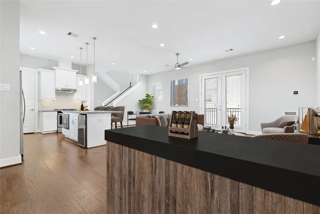 a kitchen with stainless steel appliances a refrigerator sink and cabinets