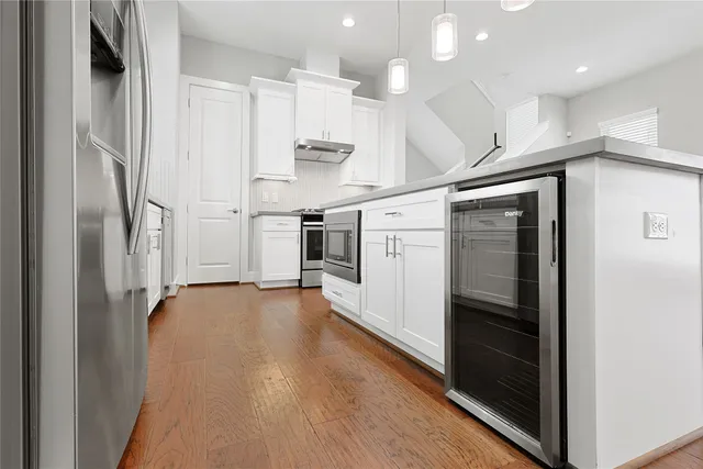 a kitchen with stainless steel appliances granite countertop a sink and a window
