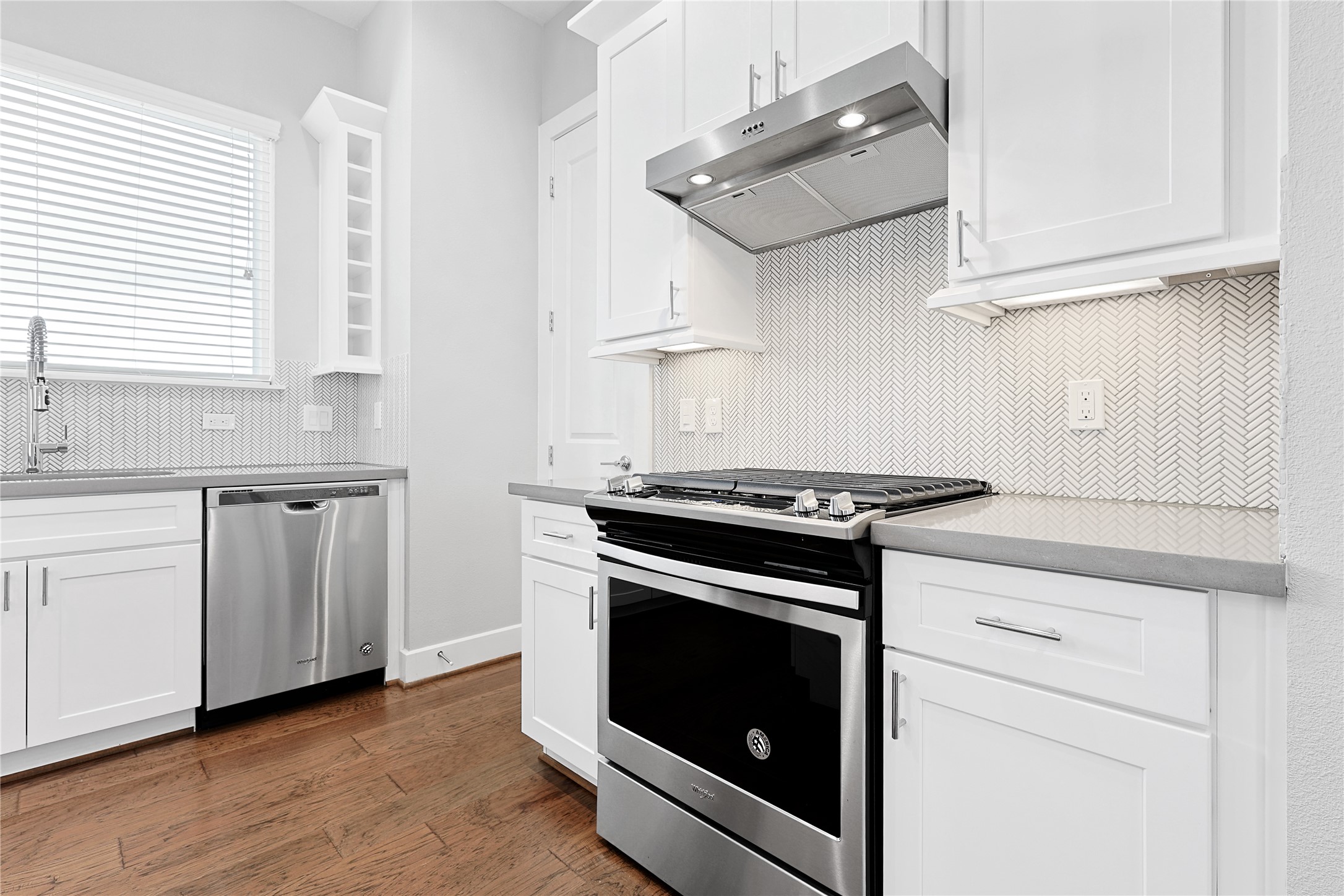 1222 Upton Street Houston, TX 77020 - Photo 15 of 41 a kitchen with stainless steel appliances white cabinets and a sink