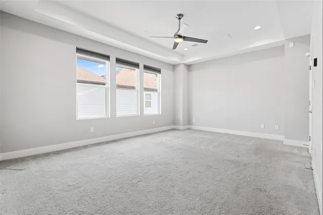 an empty room with a bathroom and a shower