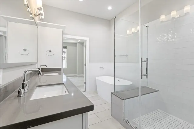a bathroom with a white bath tub and shower