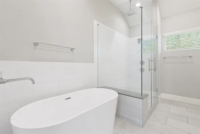 an empty room with a window and a ceiling fan