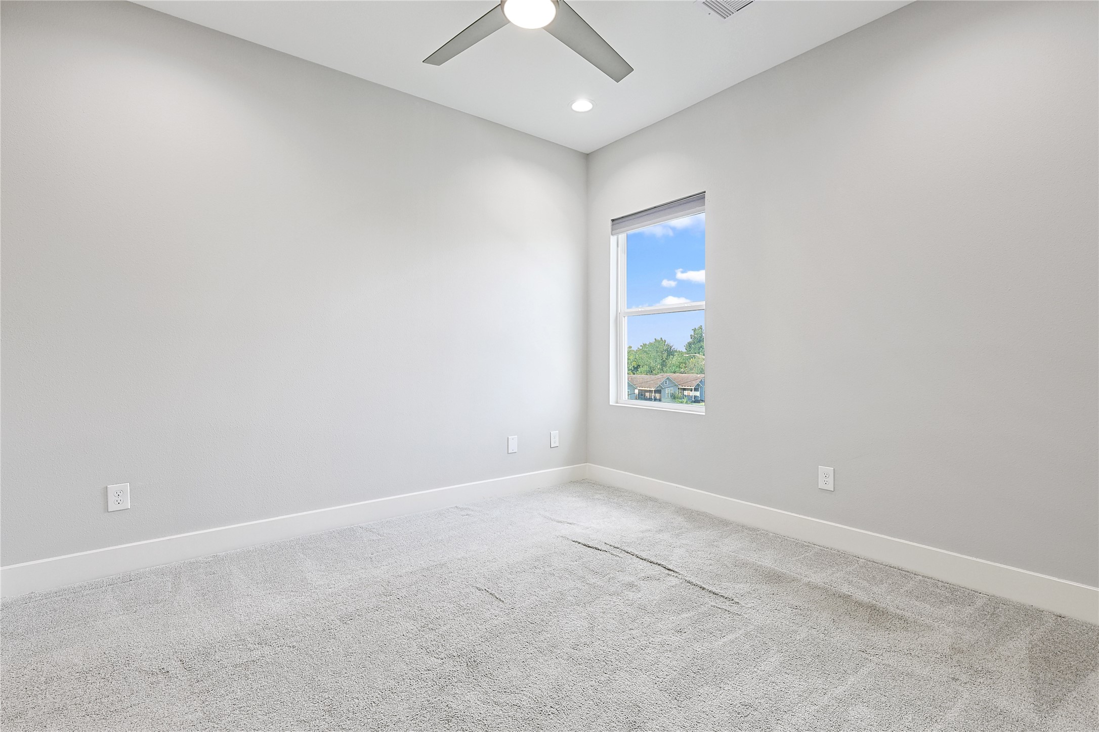 1222 Upton Street Houston, TX 77020 - Photo 27 of 41 an empty room with a window and a ceiling fan