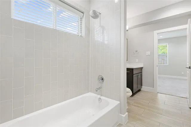 an empty room with wooden cabinet and a window