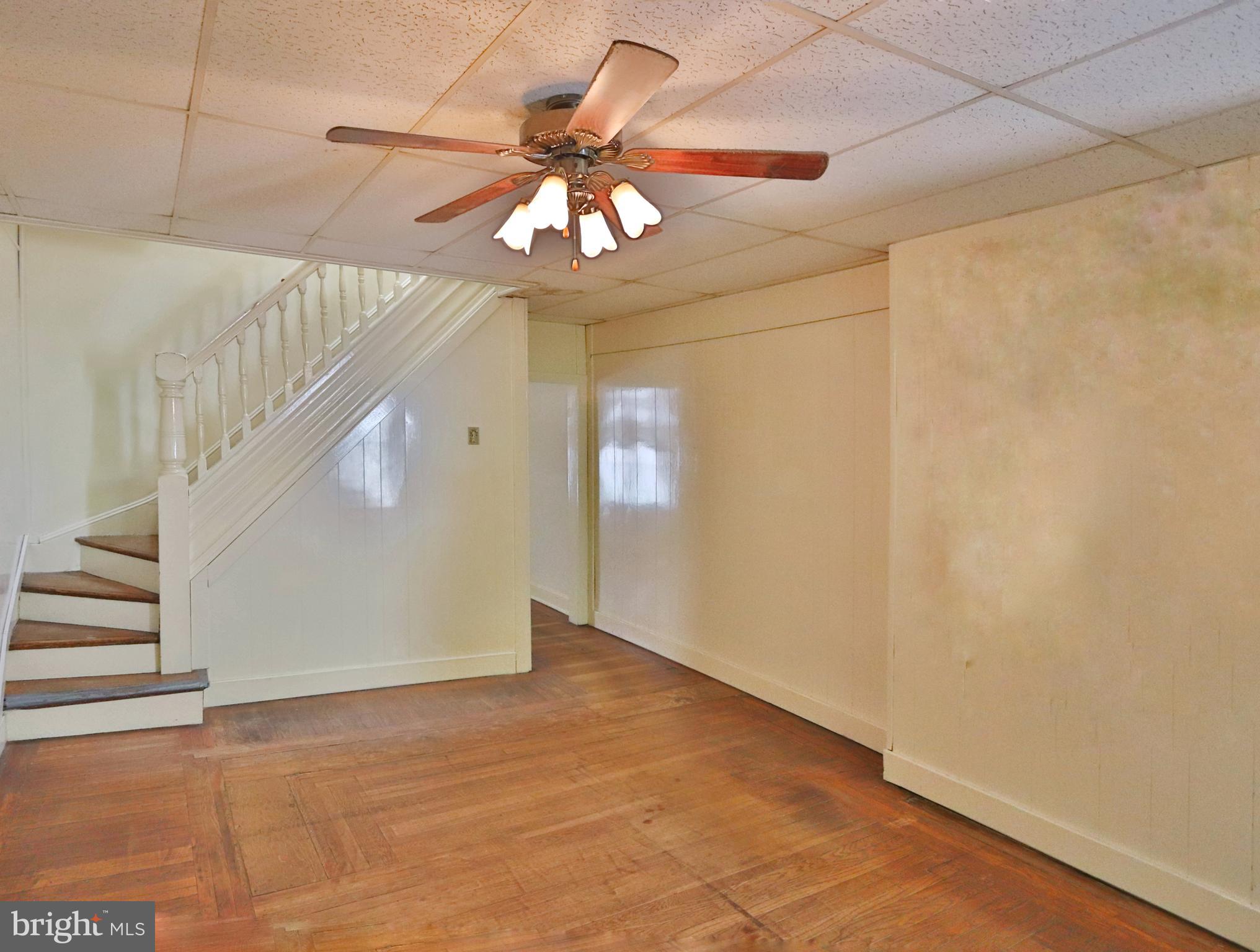 3529 Roland Avenue Baltimore, MD 21211 - Photo 3 of 16 Family room with original hardwood floors