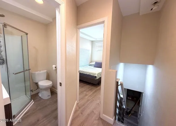 a en suite bathroom with a toilet a sink and a mirror