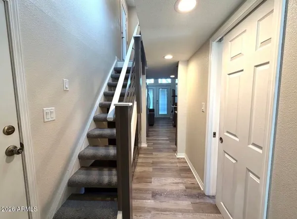 a view of entryway and hall with wooden floor