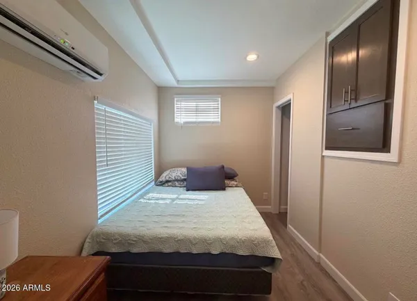 a bedroom with a bed and a painting on the wall