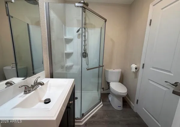 a bathroom with a sink toilet and shower