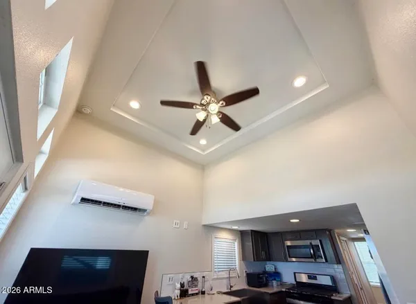 a living room with furniture and a ceiling fan