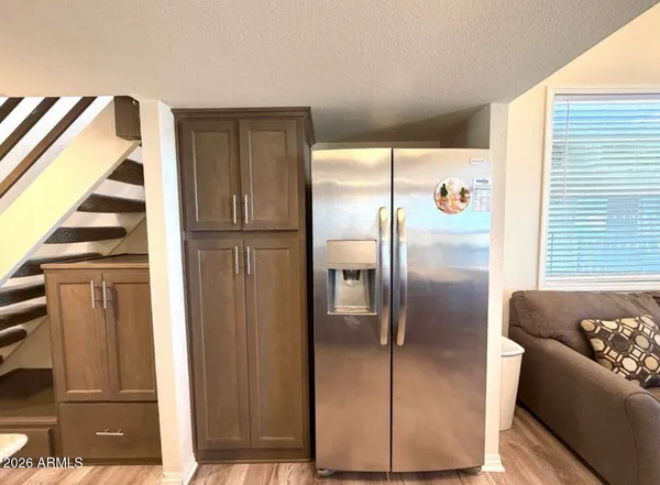 a kitchen with stainless steel appliances granite countertop a refrigerator and a stove