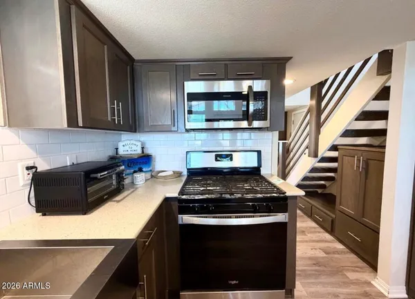 a kitchen with granite countertop a stove and a sink