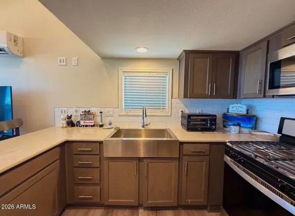 a kitchen with a sink and a stove