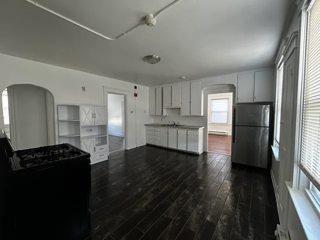 a kitchen with stainless steel appliances a refrigerator and a stove top oven