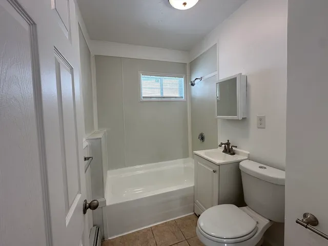 a bathroom with a toilet a sink and bathtub