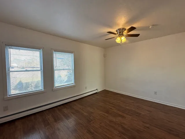 wooden floor in an empty room with a window