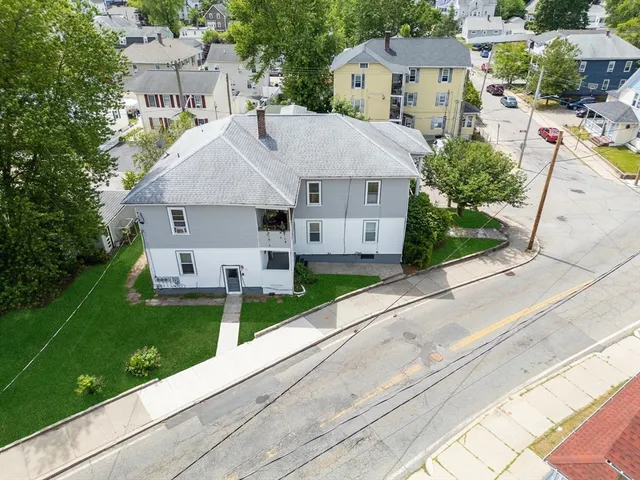 a aerial view of a house with a yard and plants