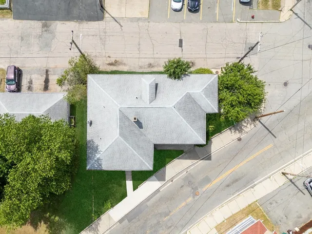 an aerial view of a house with a yard
