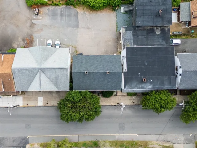 an aerial view of a house with a yard and a fountain