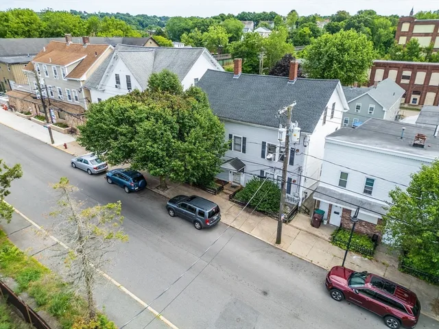 an aerial view of a house with garden space and street view