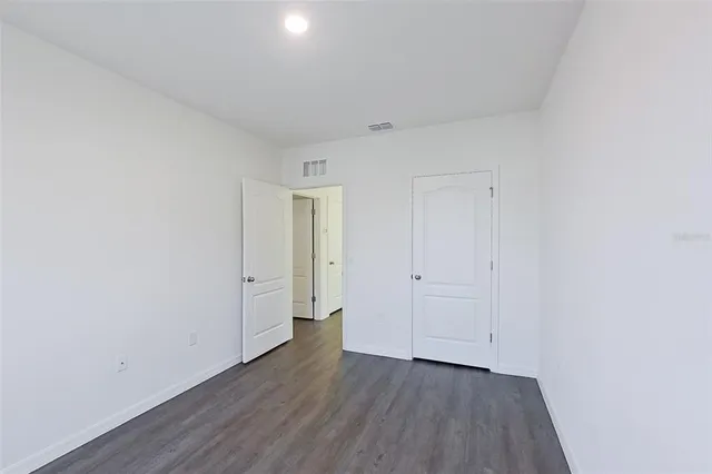 a view of an empty room and wooden floor
