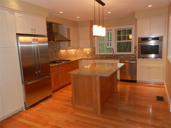 a kitchen with stainless steel appliances granite countertop a refrigerator a sink a stove and oven