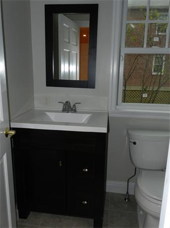 21 Glenland Road, Unit 2 Chestnut Hill, MA 02467 - Photo 12 of 30 a bathroom with a toilet sink and mirror