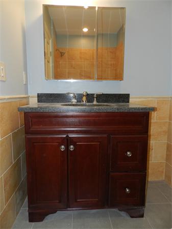 21 Glenland Road, Unit 2 Chestnut Hill, MA 02467 - Photo 13 of 30 a bathroom with a sink and a mirror