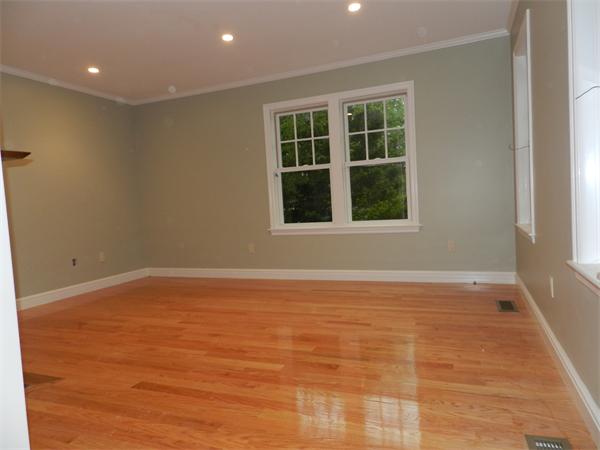 21 Glenland Road, Unit 2 Chestnut Hill, MA 02467 - Photo 19 of 30 a view of an empty room with wooden floor and a window