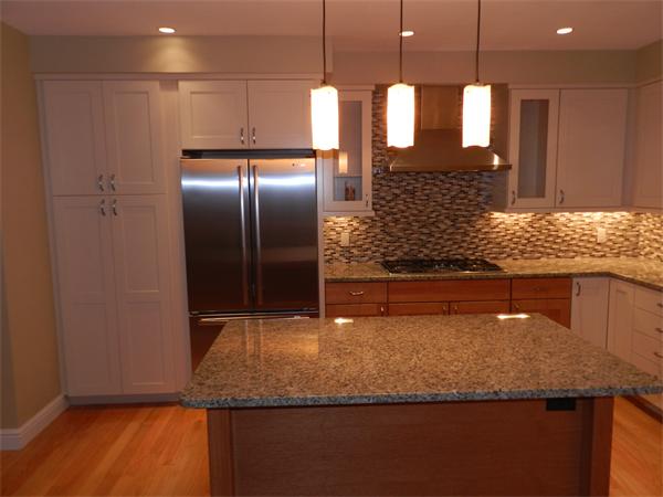 21 Glenland Road, Unit 2 Chestnut Hill, MA 02467 - Photo 3 of 30 a kitchen with kitchen island a counter top space a sink and refrigerator