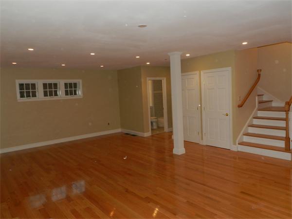 21 Glenland Road, Unit 2 Chestnut Hill, MA 02467 - Photo 6 of 30 an empty room with wooden floor and windows