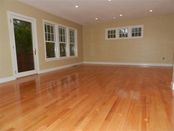 21 Glenland Road, Unit 2 Chestnut Hill, MA 02467 - Photo 8 of 30 a view of an empty room with wooden floor and a window