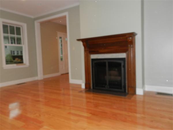 21 Glenland Road, Unit 2 Chestnut Hill, MA 02467 - Photo 9 of 30 a view of an empty room with wooden floor and a window