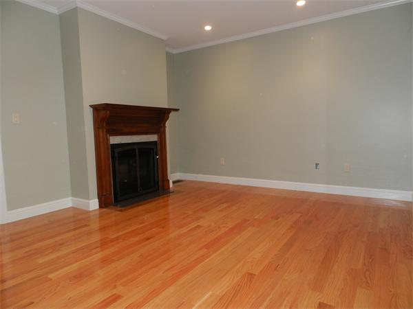 21 Glenland Road, Unit 2 Chestnut Hill, MA 02467 - Photo 10 of 30 a view of empty room with wooden floor and fireplace