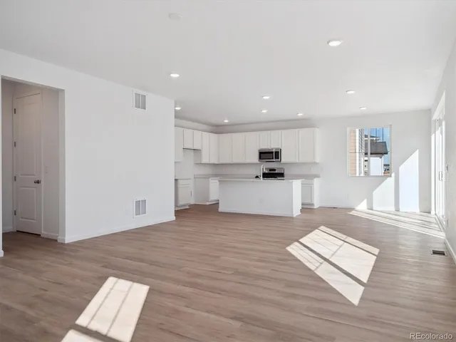 a view of kitchen with sink microwave and refrigerator