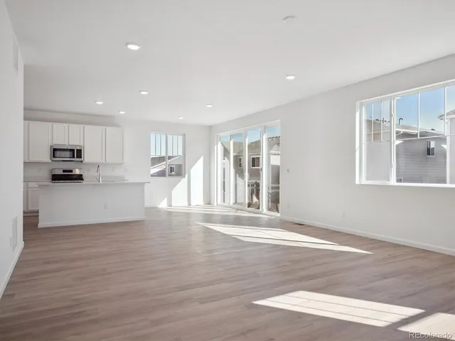 a view of a kitchen with a sink and cabinets